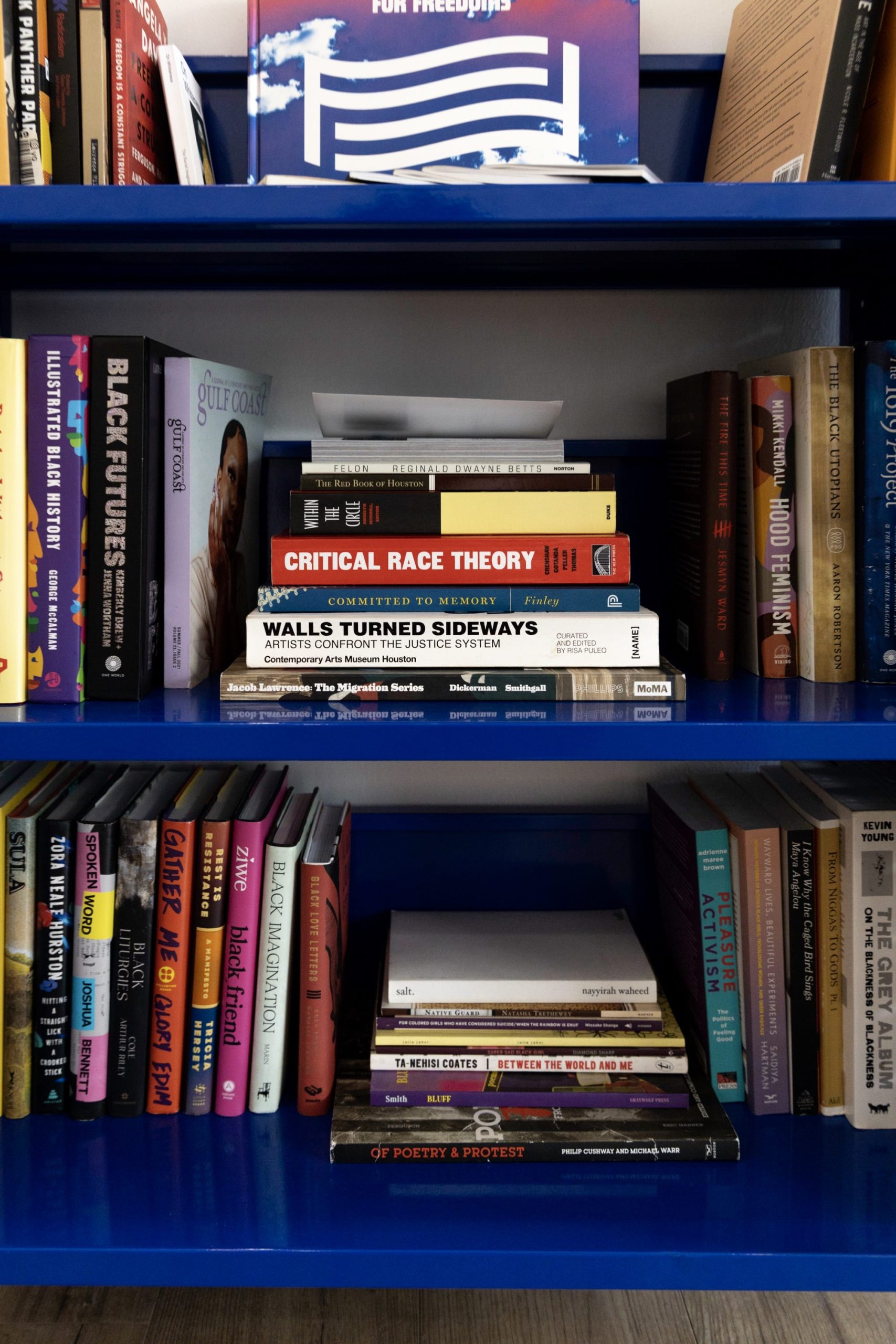 a close up of a blue library cart with books on it