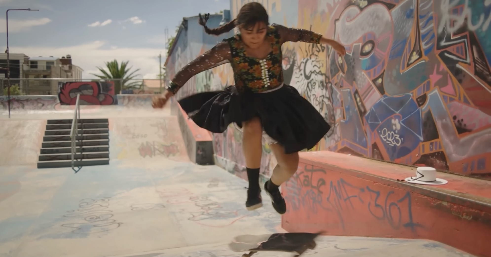 a still from a documentary showing Quechuan women skateboarding