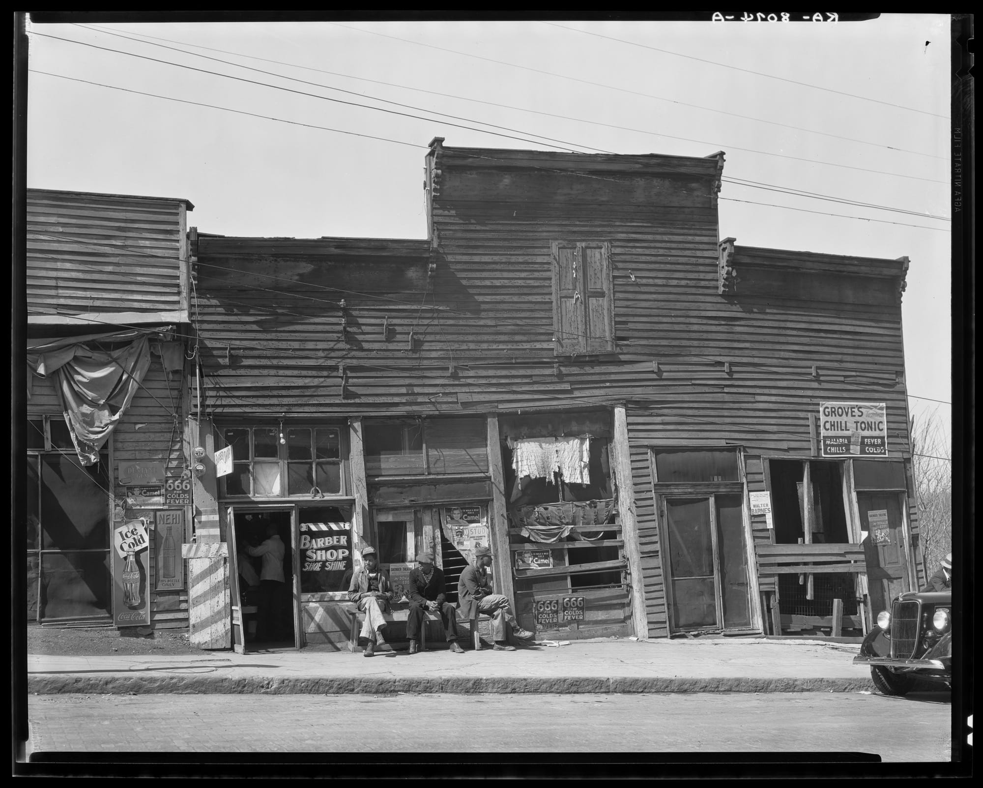 storefronts in Vicksburg, Mississippi, featuring segregated businesses for Black people, including a barber shop