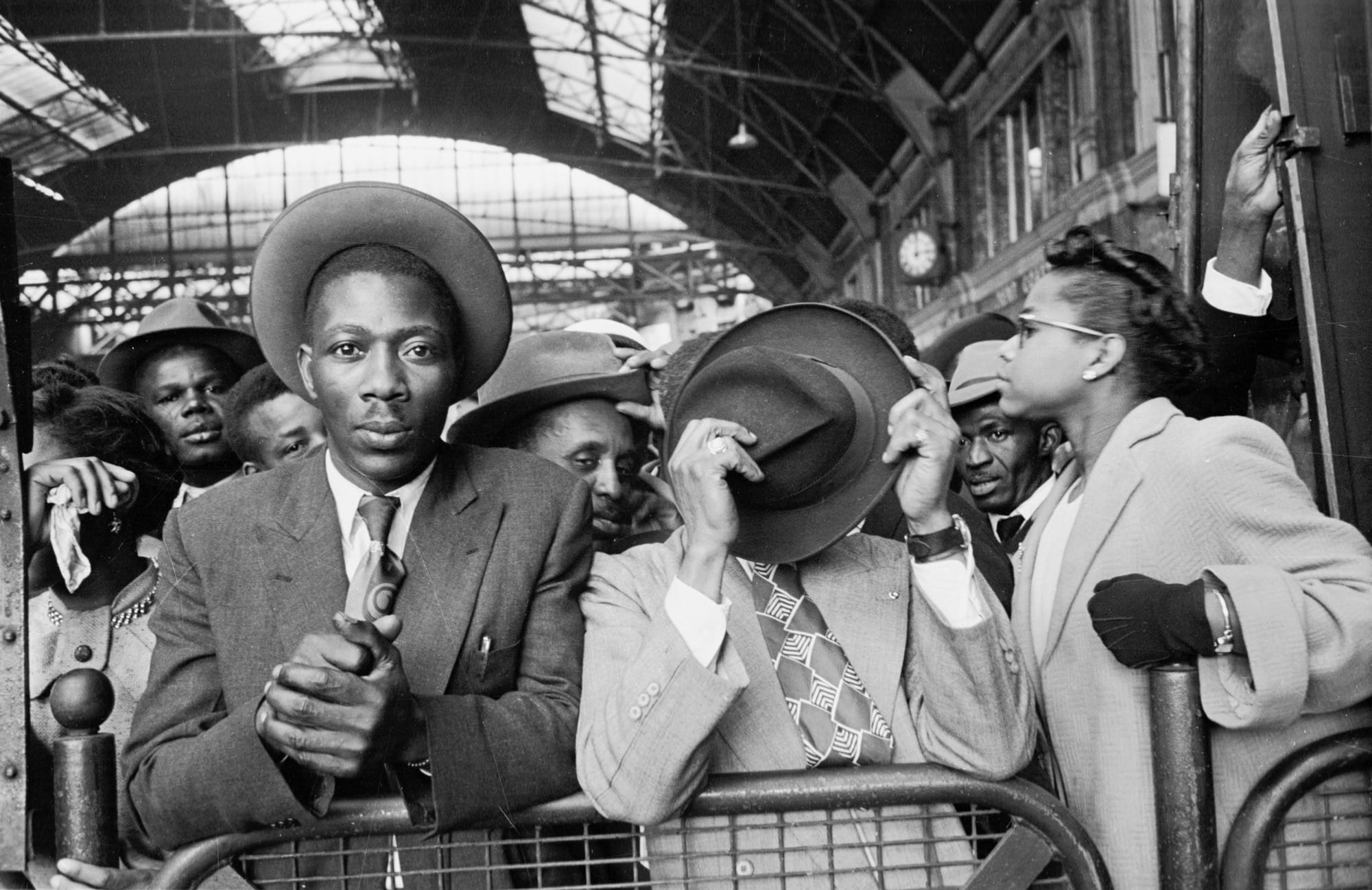 a black and white photo by Haywood Magee of people in a hall