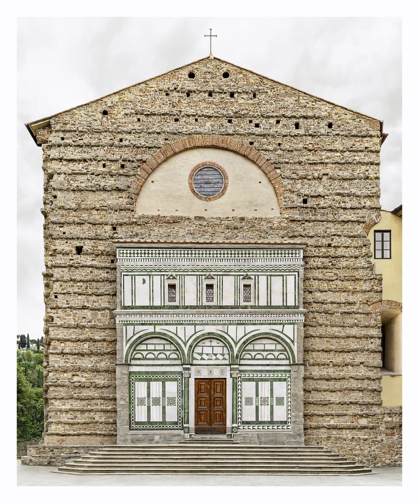 A fine art photograph by Marcus Brunetti of the facade of a historic church in Europe